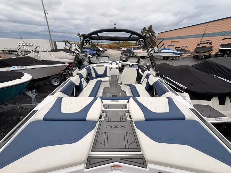Slide: The Image of The image shows a 2021 Tigé 22RZX boat with blue and white seating and a modern design. - 11