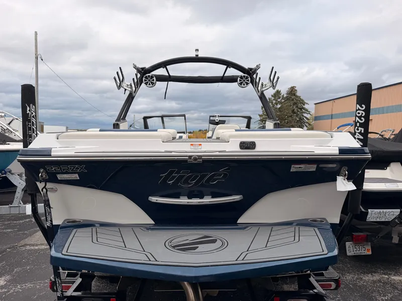Slide: The Image of The image shows the rear of a 2021 Tigé 22RZX boat with sleek design and a tower. - 8