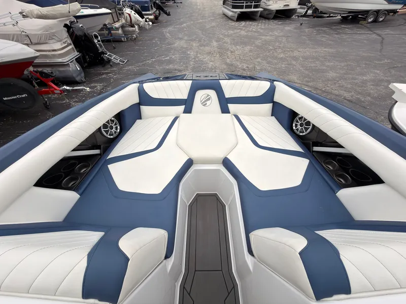 Slide: The Image of The image shows the bow area of a 2021 Tigé 22RZX with blue and white upholstery. - 46