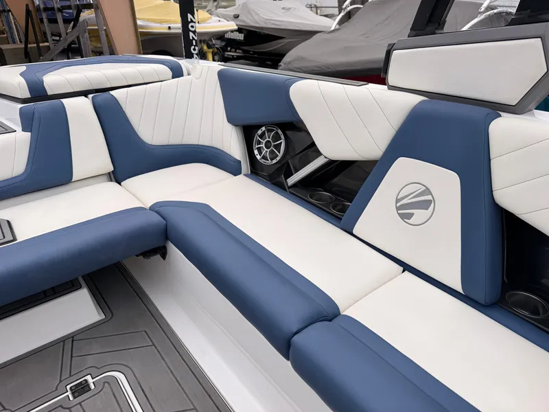 Slide: The Image of The image shows the luxurious blue and white upholstery of a 2021 Tigé 22RZX boat. - 23