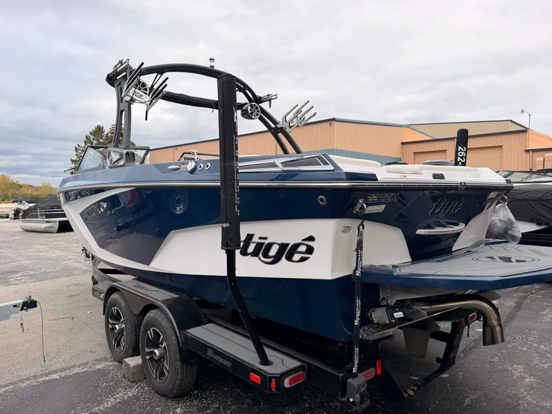 The Image of A blue 2021 Tigé 22RZX boat on a trailer, ready for use. - 0