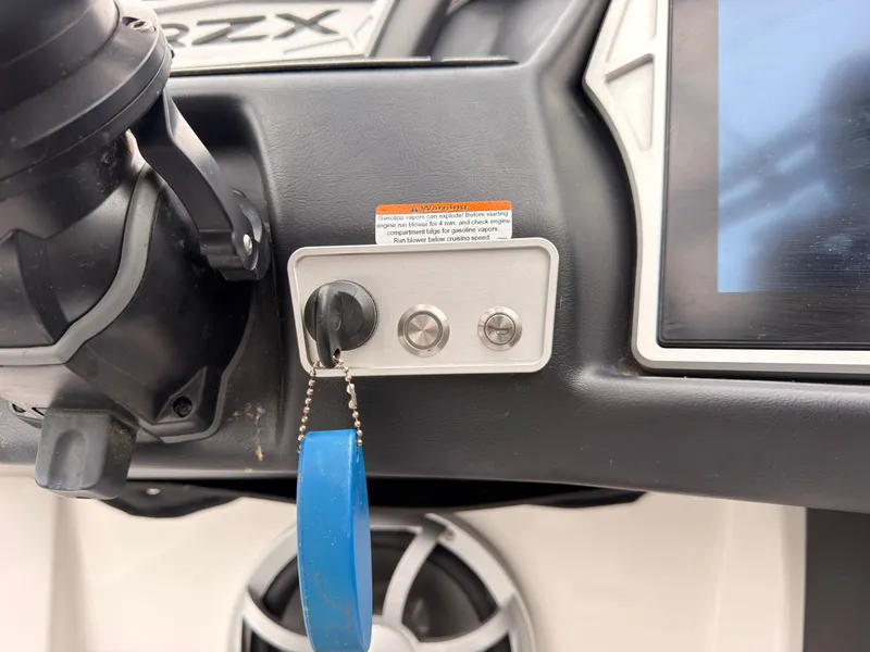 Slide: The Image of Close-up of a 2021 Tigé 22RZX ignition switch with a blue keychain. - 42
