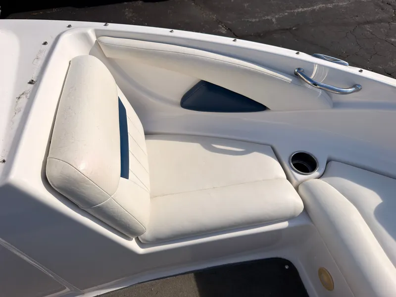 Slide: The Image of White seating area in the bow of a boat with blue accent and stainless steel handle. - 32