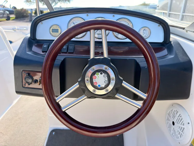 Slide: The Image of The image shows the cockpit of a 2008 Regal 1900 Bowrider with a wooden steering wheel. - 24