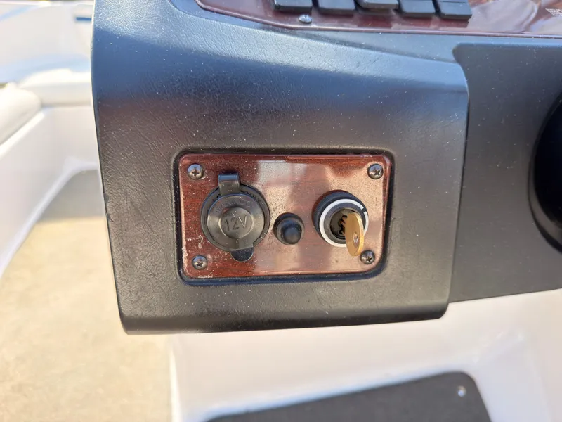 Slide: The Image of Close-up of a boat panel with a 12V socket and ignition key. - 25