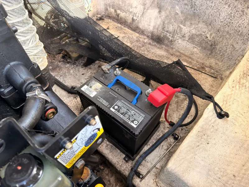 Slide: The Image of Battery in a 2008 Regal 1900 Bowrider, with cables and engine compartment. - 14