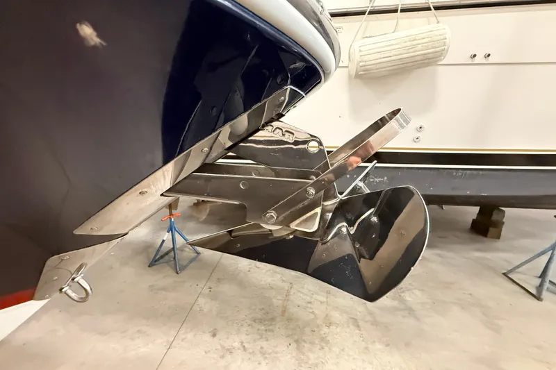 Slide: The Image of 2019 Chris-Craft Launch 27 boat propeller and trim tab detail in a storage facility. - 29