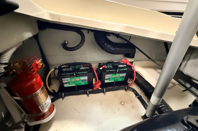 Slide: The Image of 2019 Chris-Craft Launch 27 engine compartment with batteries and fire extinguisher. - 28