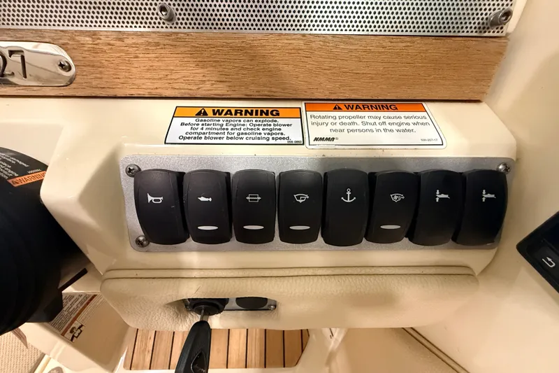 Slide: The Image of Control panel of a 2019 Chris-Craft Launch 27 boat with warning labels and switches. - 20