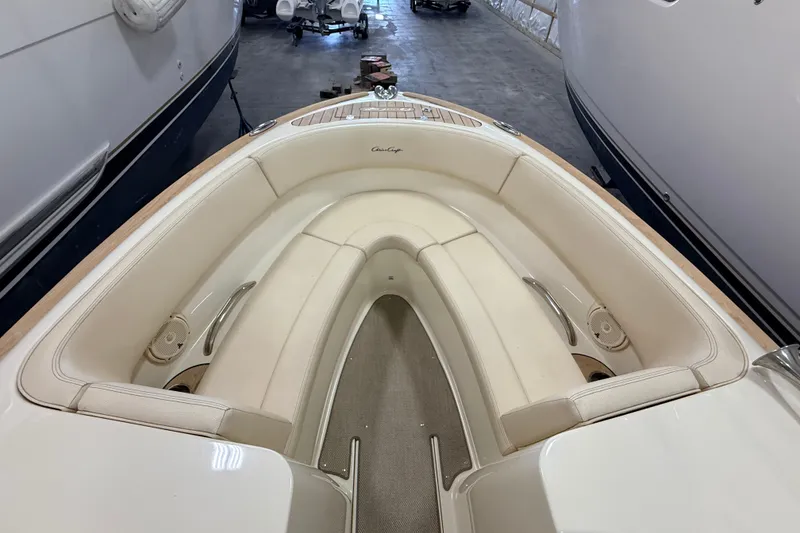 Slide: The Image of 2019 Chris-Craft Launch 27 boat interior with cream seating in a storage facility. - 15