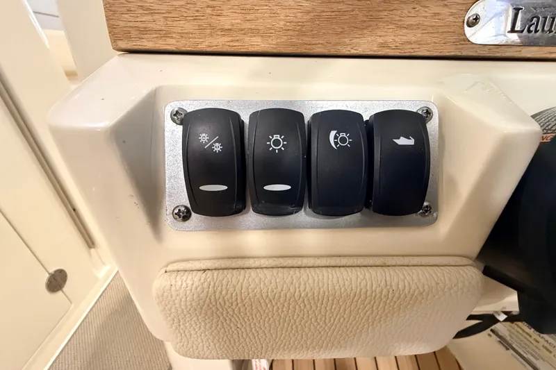 Slide: The Image of Control panel with switches on a 2019 Chris-Craft Launch 27 boat. - 21