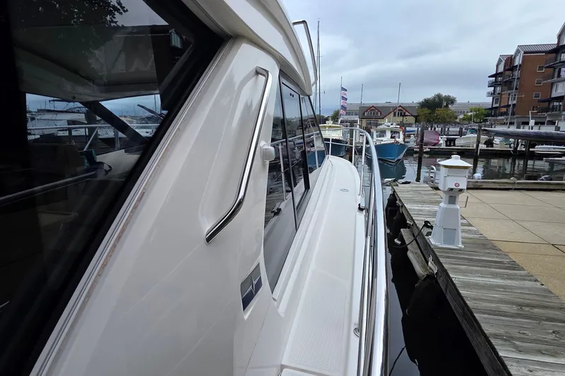 Slide: The Image of 2015 Bavaria 360 Sport HT yacht docked at a marina, showcasing sleek design and modern features. - 5