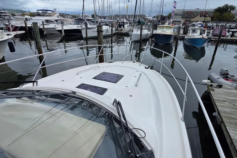 Slide: The Image of Bavaria 360 Sport HT 2015 docked at a marina with other boats. - 6