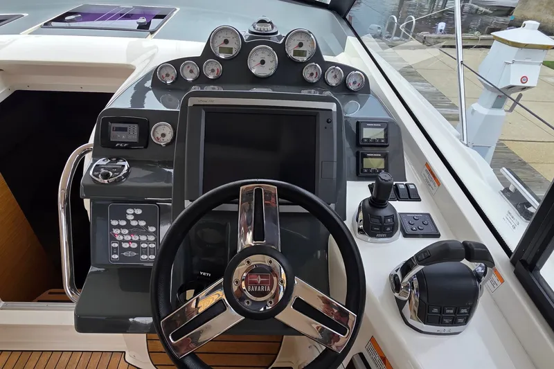 Slide: The Image of Cockpit of 2015 Bavaria 360 Sport HT with steering wheel and control panel. - 19