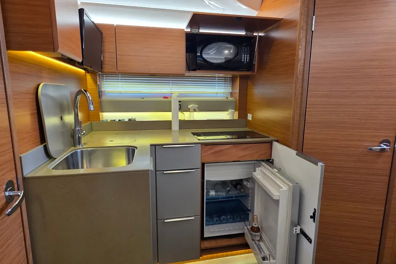Slide: The Image of Modern kitchen interior of 2015 Bavaria 360 Sport HT yacht with wood finish and appliances. - 28