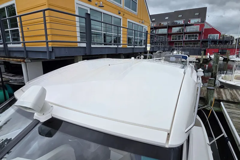 Slide: The Image of 2015 Bavaria 360 Sport HT yacht docked near colorful waterfront buildings. - 8