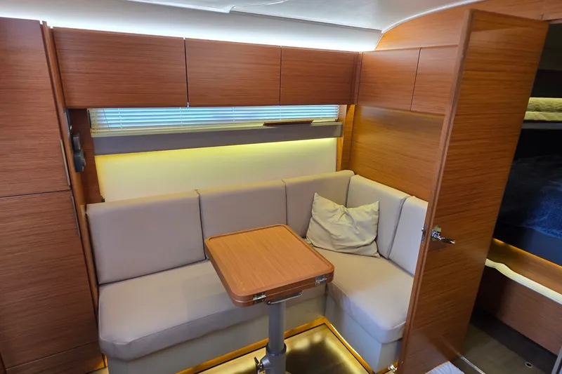 Slide: The Image of Interior of 2015 Bavaria 360 Sport HT yacht with cozy seating and wooden finishes. - 25