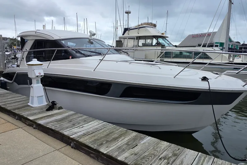 Slide: The Image of 2015 Bavaria 360 Sport HT yacht docked at a marina on a cloudy day. - 1