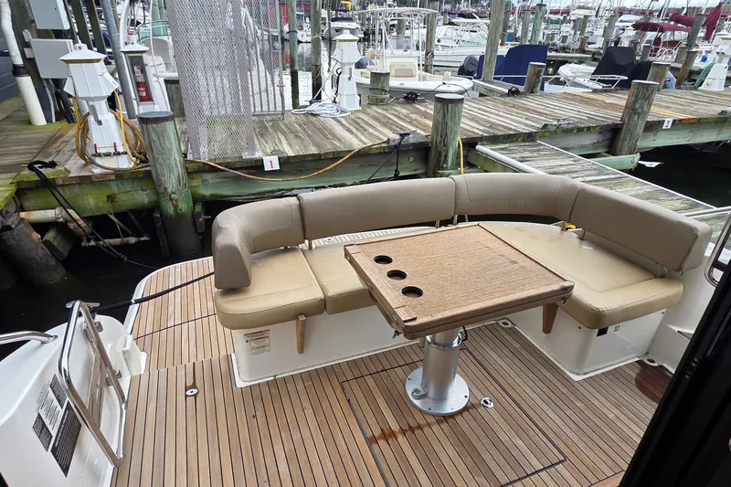 Slide: The Image of Bavaria 360 Sport HT 2015 yacht with teak deck and cushioned seating at marina. - 11