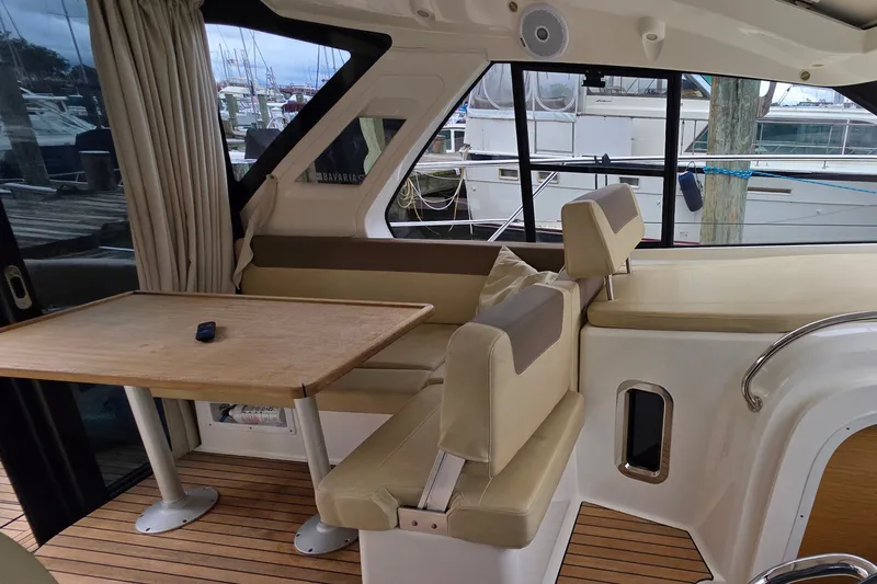 Slide: The Image of Interior of 2015 Bavaria 360 Sport HT yacht with seating and table, docked at marina. - 17