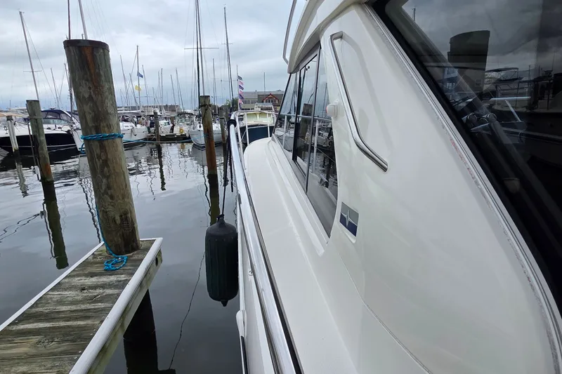 Slide: The Image of 2015 Bavaria 360 Sport HT yacht docked at a marina, surrounded by other boats. - 9