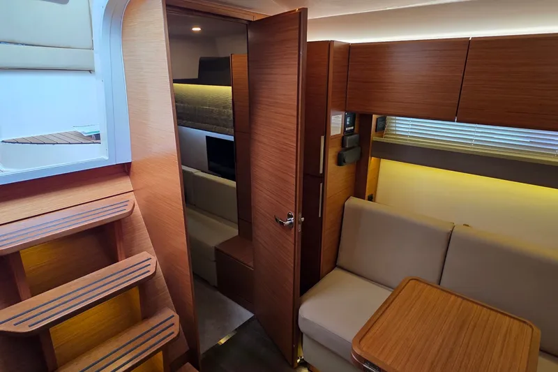 Slide: The Image of Interior of 2015 Bavaria 360 Sport HT yacht with wooden finishes and cozy seating area. - 37