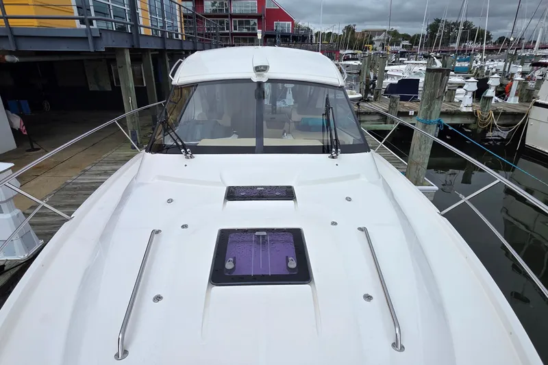 Slide: The Image of 2015 Bavaria 360 Sport HT yacht docked at marina, showcasing sleek design and spacious deck. - 7
