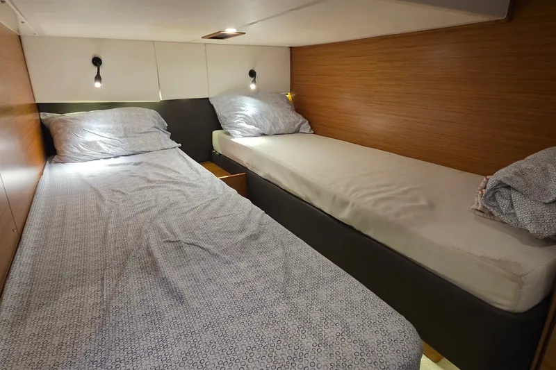 Slide: The Image of Twin beds in a 2015 Bavaria 360 Sport HT yacht cabin, featuring modern wood paneling. - 39