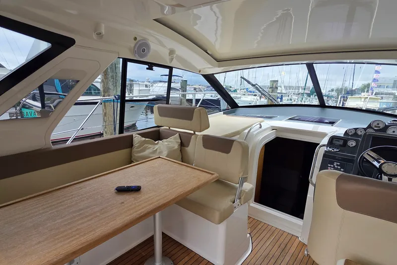 Slide: The Image of Interior of 2015 Bavaria 360 Sport HT yacht with helm, seating, and table. - 15