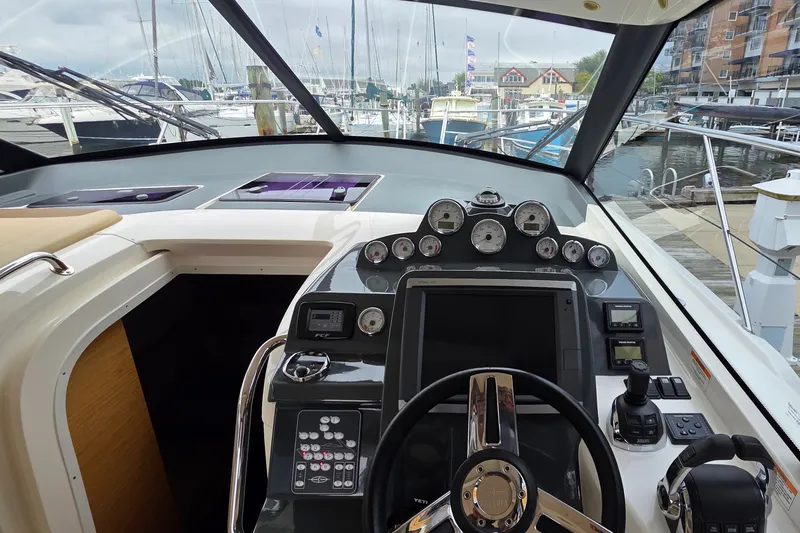 Slide: The Image of Cockpit view of a 2015 Bavaria 360 Sport HT yacht at a marina. - 20