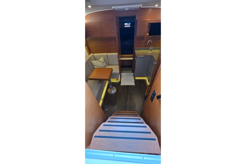 Slide: The Image of Interior of 2015 Bavaria 360 Sport HT yacht with modern wood finish and cozy seating area. - 23