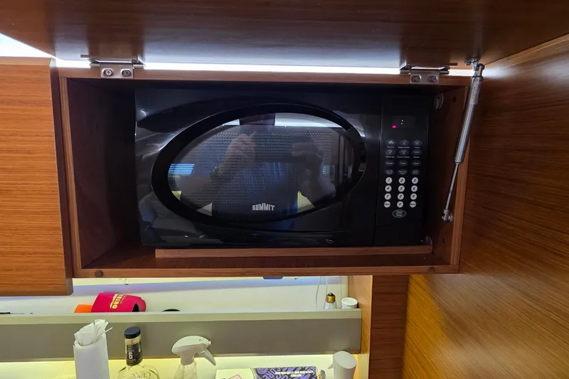 Slide: The Image of Microwave in Bavaria 360 Sport HT yacht kitchen, 2015 model, with wooden cabinetry. - 31