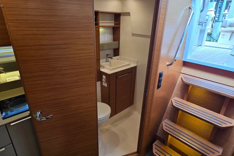 Slide: The Image of Interior of 2015 Bavaria 360 Sport HT yacht featuring a compact bathroom and wooden staircase. - 34