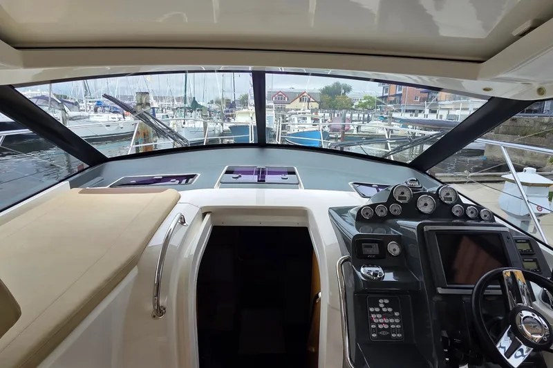 Slide: The Image of Interior view of 2015 Bavaria 360 Sport HT yacht cockpit with marina background. - 21