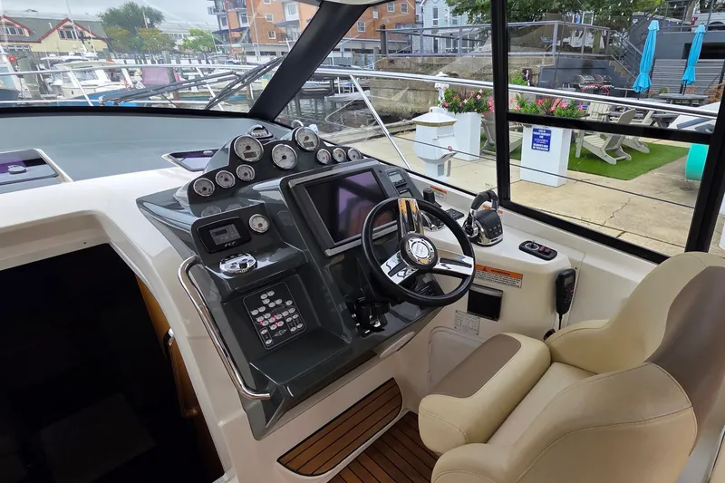 Slide: The Image of Cockpit of 2015 Bavaria 360 Sport HT yacht with modern controls and steering wheel. - 18