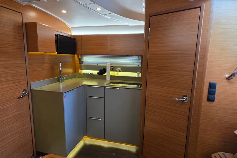 Slide: The Image of Modern kitchen interior of 2015 Bavaria 360 Sport HT yacht with sleek wood finish. - 26