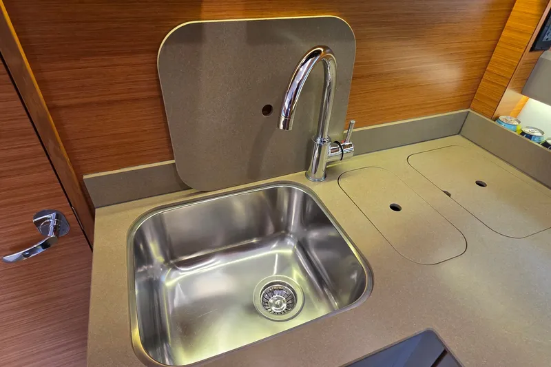 Slide: The Image of Modern kitchen sink in 2015 Bavaria 360 Sport HT yacht, featuring sleek design and wood accents. - 32