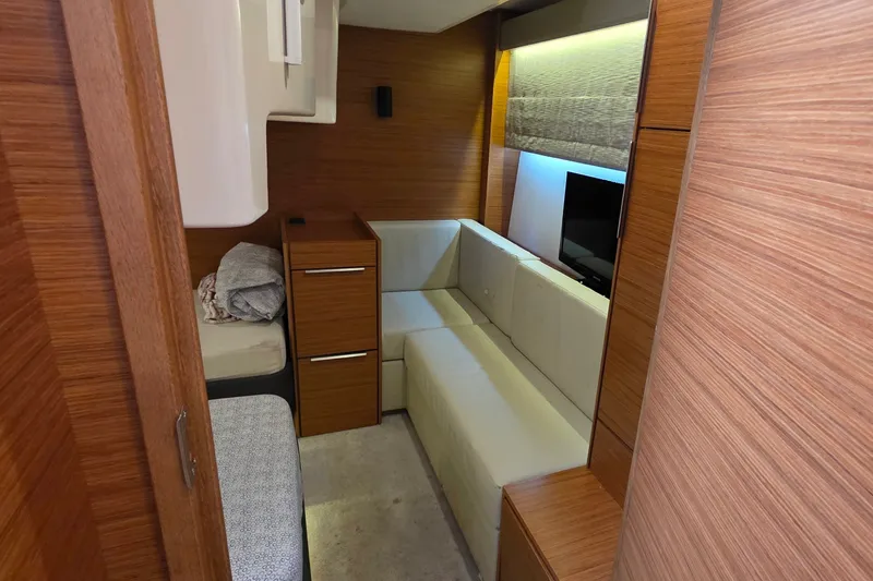 Slide: The Image of Interior of 2015 Bavaria 360 Sport HT yacht with modern wood paneling and cozy seating area. - 38
