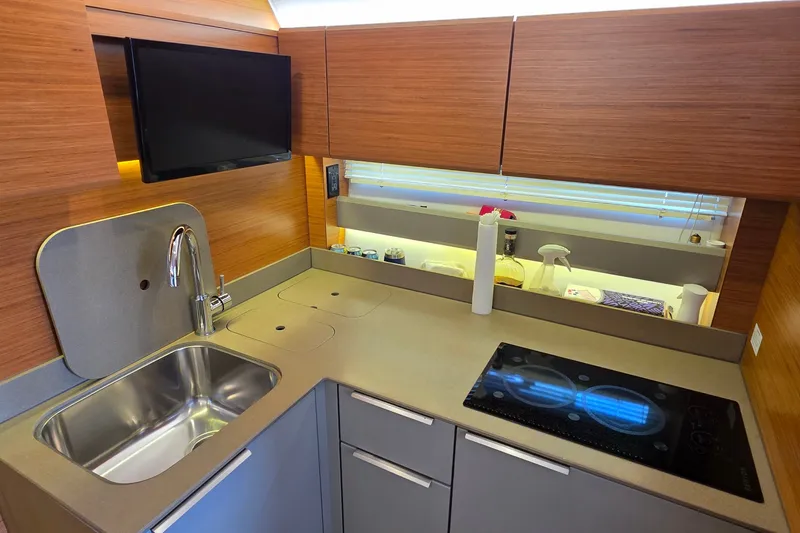 Slide: The Image of Modern kitchen interior of 2015 Bavaria 360 Sport HT yacht with sink and stove. - 27