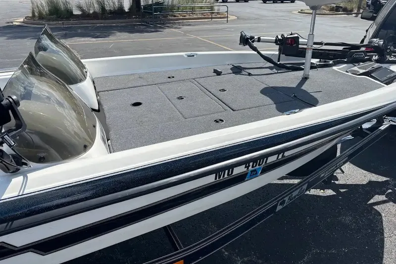 Slide: The Image of 2004 Bass Cat Pantera Classic boat with dual windshields and spacious deck in parking lot. - 5
