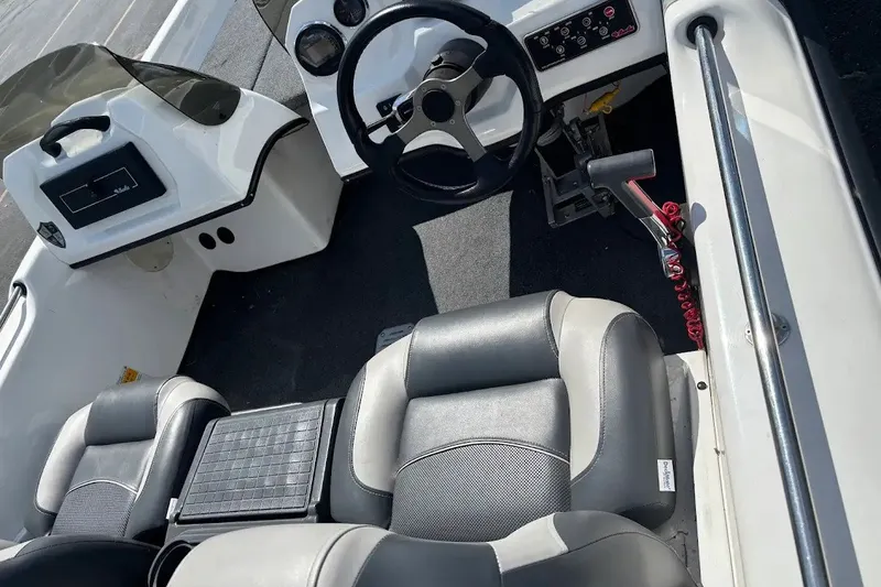 Slide: The Image of 2004 Bass Cat Pantera Classic boat interior with steering wheel and seating. - 1