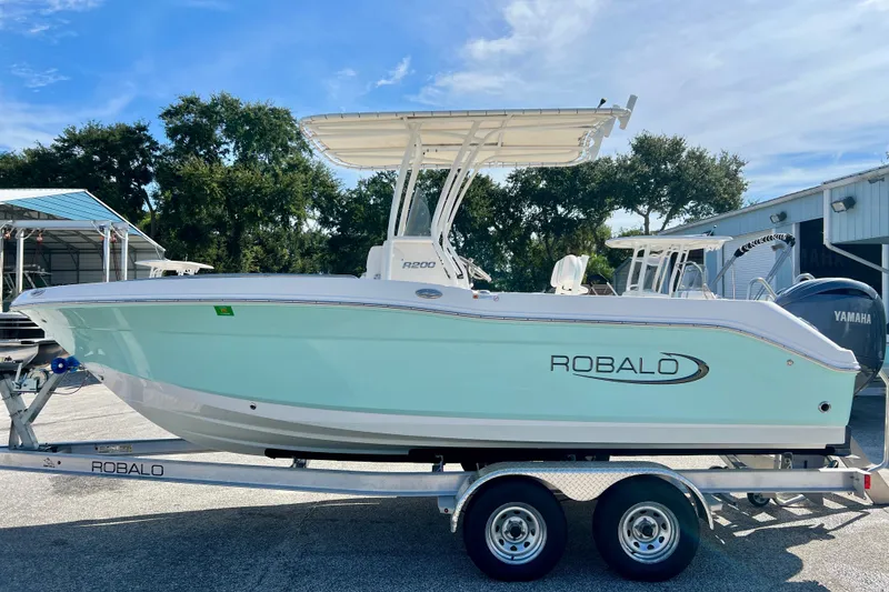 Slide: The Image of 2024 Robalo R200 Center Console boat on trailer, parked outdoors. - 5