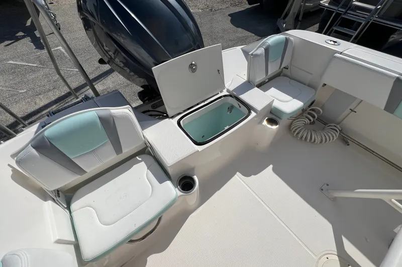 Slide: The Image of 2024 Robalo R200 Center Console boat interior with seating and storage compartment. - 8