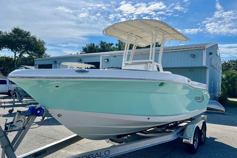 Slide: The Image of 2024 Robalo R200 Center Console boat on trailer, light blue hull, sunny day. - 4