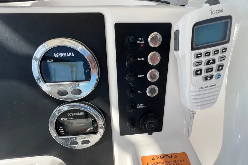 Slide: The Image of 2024 Robalo R200 Center Console dashboard with Yamaha gauges and Icom radio. - 11