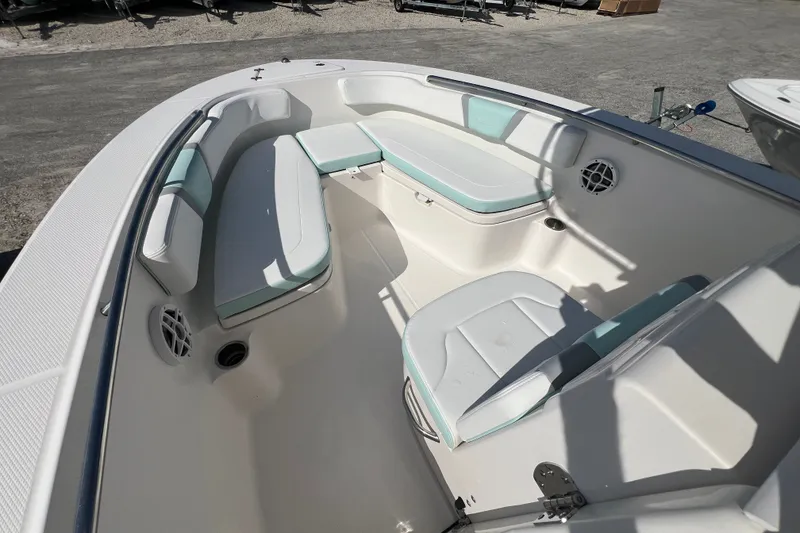 Slide: The Image of 2024 Robalo R200 Center Console boat interior with cushioned seating and storage. - 14