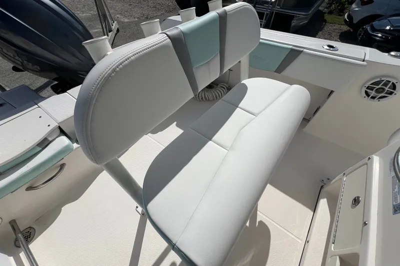 Slide: The Image of 2024 Robalo R200 Center Console boat interior with cushioned seating and storage. - 9