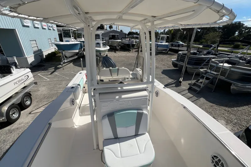 Slide: The Image of 2024 Robalo R200 Center Console boat displayed at a dealership, showcasing seating and console design. - 17