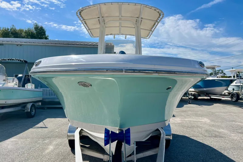 Slide: The Image of 2024 Robalo R200 Center Console boat on trailer under clear blue sky. - 3