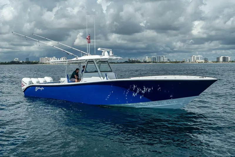 Slide: The Image of 2023 Yellowfin 39 Offshore boat on water with city skyline background. - 8